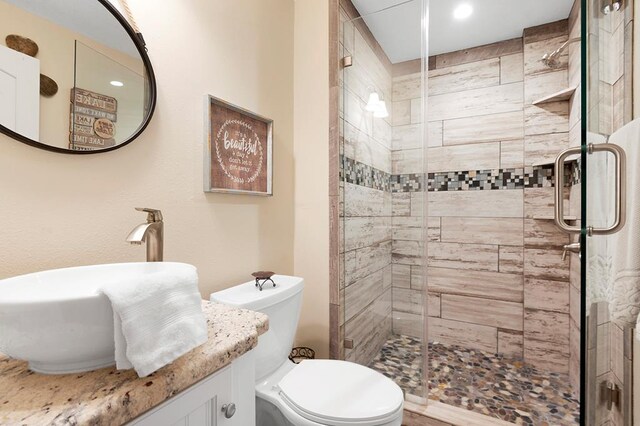 671 Lakeshore Dr, Brookeland, TX 75931 - bathroom featuring a stall shower, vanity, and recessed lighting