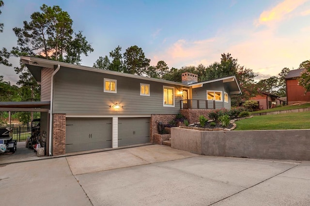 671 Lakeshore Dr, Brookeland, TX 75931 - mid-century modern home featuring brick siding, an attached garage, and driveway