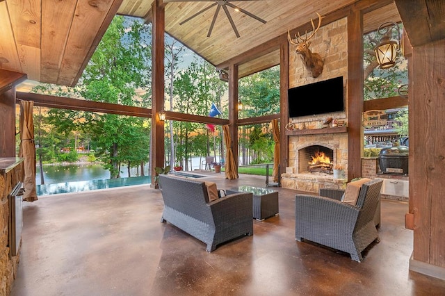 671 Lakeshore Dr, Brookeland, TX 75931 - living area with finished concrete floors, a stone fireplace, wooden ceiling, high vaulted ceiling, and healthy amount of natural light