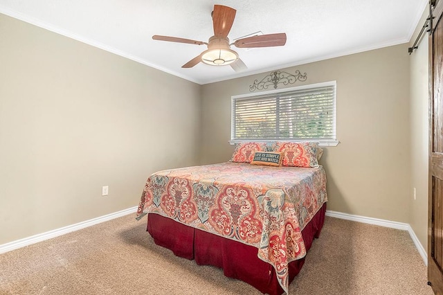 671 Lakeshore Dr, Brookeland, TX 75931 - carpeted bedroom with ornamental molding, ceiling fan, and a barn door