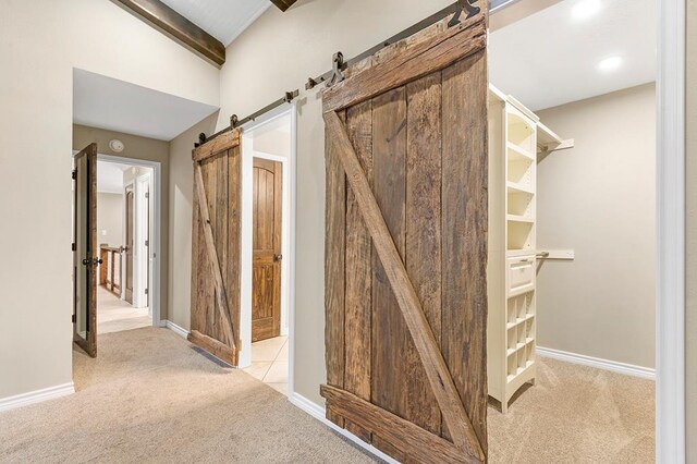 671 Lakeshore Dr, Brookeland, TX 75931 - hall featuring a barn door, light carpet, lofted ceiling, and recessed lighting