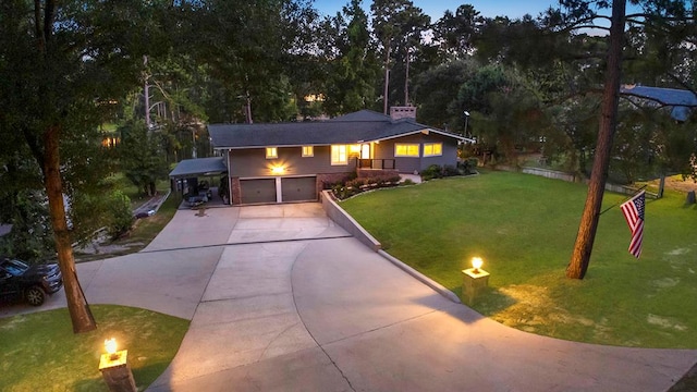 671 Lakeshore Dr, Brookeland, TX 75931 - view of front of house with a front yard, concrete driveway, and a garage