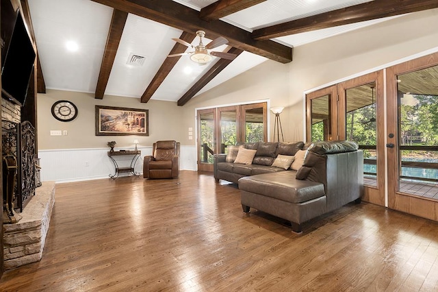 671 Lakeshore Dr, Brookeland, TX 75931 - living room featuring hardwood / wood-style flooring, a ceiling fan, a wainscoted wall, and french doors