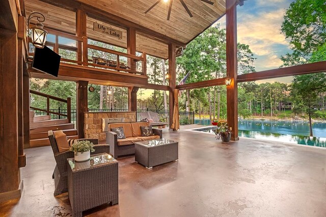 671 Lakeshore Dr, Brookeland, TX 75931 - patio terrace at dusk with ceiling fan, a pool, a patio area, a water view, and an outdoor living space