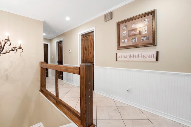 671 Lakeshore Dr, Brookeland, TX 75931 - hall featuring tile patterned flooring, a wainscoted wall, a chandelier, and ornamental molding