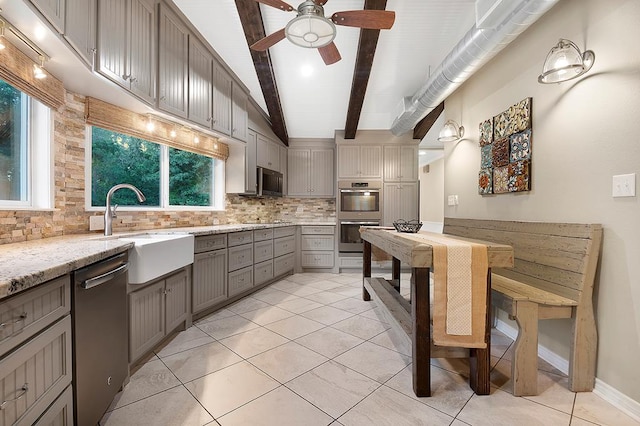 671 Lakeshore Dr, Brookeland, TX 75931 - kitchen featuring appliances with stainless steel finishes, gray cabinets, decorative backsplash, a ceiling fan, and light stone countertops