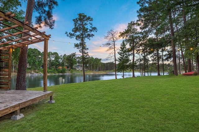 671 Lakeshore Dr, Brookeland, TX 75931 - yard at dusk with a water view and a yard