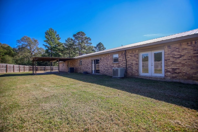 exterior space with central AC unit and french doors