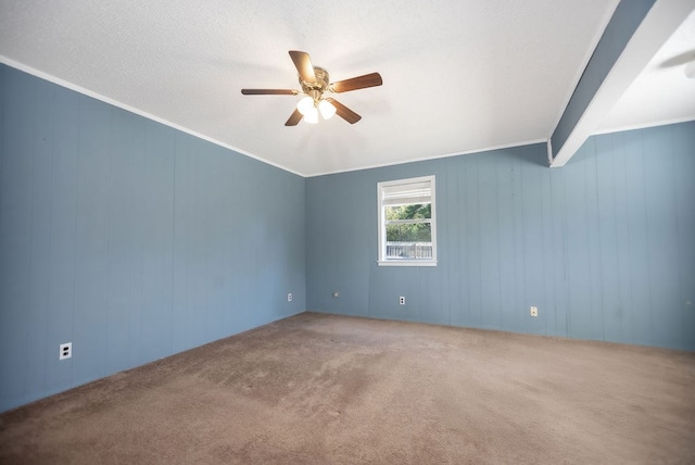 spare room featuring beam ceiling, ceiling fan, carpet, and ornamental molding