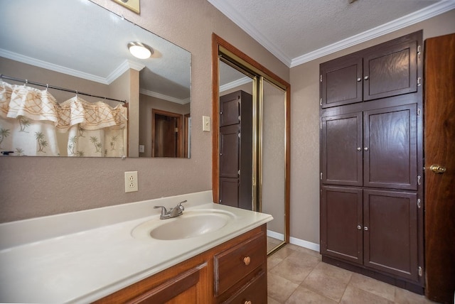 bathroom featuring tile patterned flooring, vanity, crown molding, and a textured ceiling