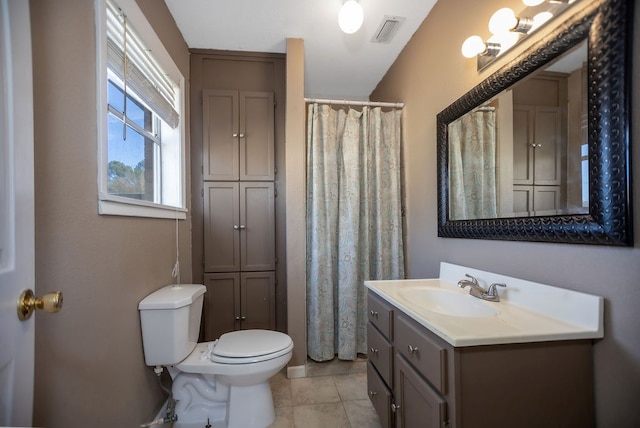 bathroom featuring tile patterned flooring, vanity, and toilet