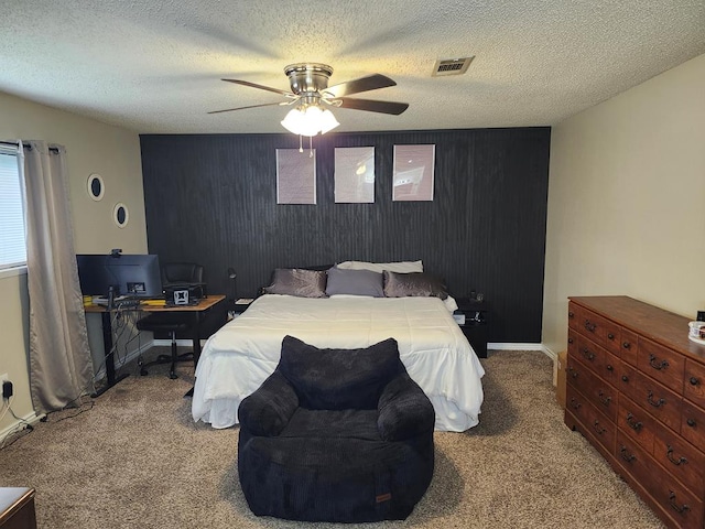 1805 Hanks St, Lufkin, TX 75904 - carpeted bedroom with an accent wall, a ceiling fan, a textured ceiling, and an office area