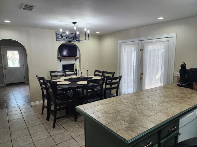 1805 Hanks St, Lufkin, TX 75904 - dining room featuring light tile patterned floors, a chandelier, recessed lighting, and arched walkways