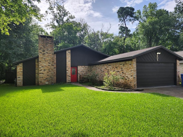 1805 Hanks St, Lufkin, TX 75904 - view of front facade featuring an attached garage, a front yard, driveway, a chimney, and brick siding