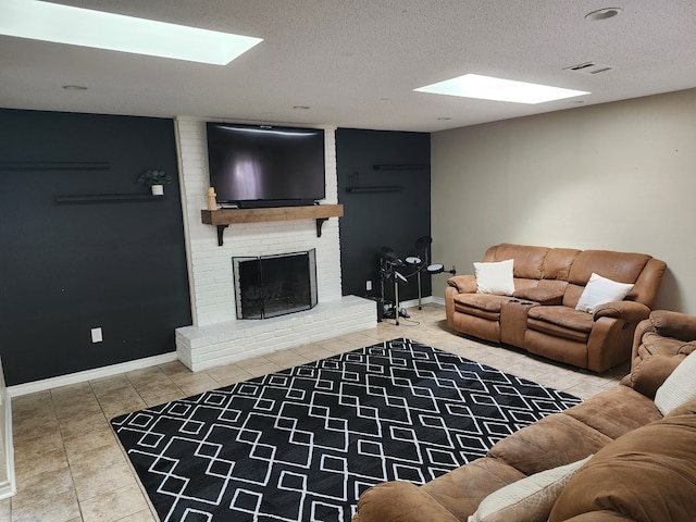 1805 Hanks St, Lufkin, TX 75904 - tiled living area with a textured ceiling, a brick fireplace, and a skylight