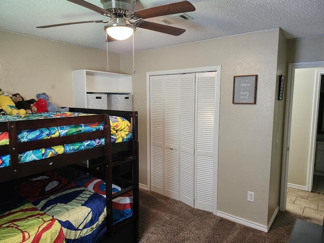 1805 Hanks St, Lufkin, TX 75904 - carpeted bedroom with a textured ceiling, a closet, a ceiling fan, and a textured wall