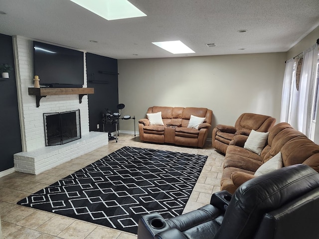 1805 Hanks St, Lufkin, TX 75904 - living room with tile patterned floors, a fireplace, a skylight, and a textured ceiling