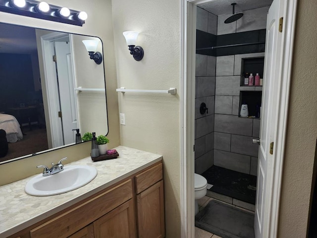 1805 Hanks St, Lufkin, TX 75904 - ensuite bathroom with a tile shower, vanity, and a textured wall