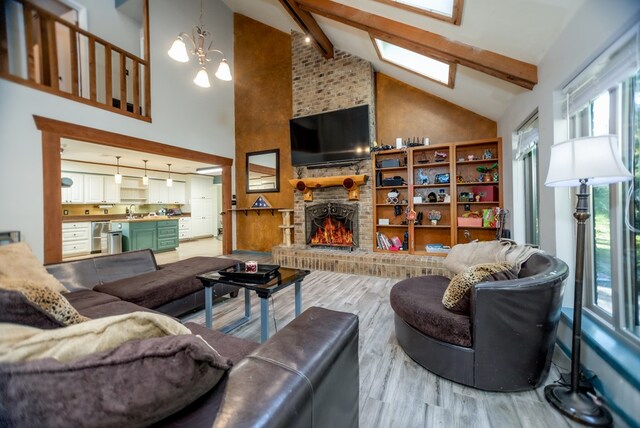 310 Karen Dr, Lufkin, TX 75904 - living area with an inviting chandelier, beam ceiling, wood finished floors, and high vaulted ceiling