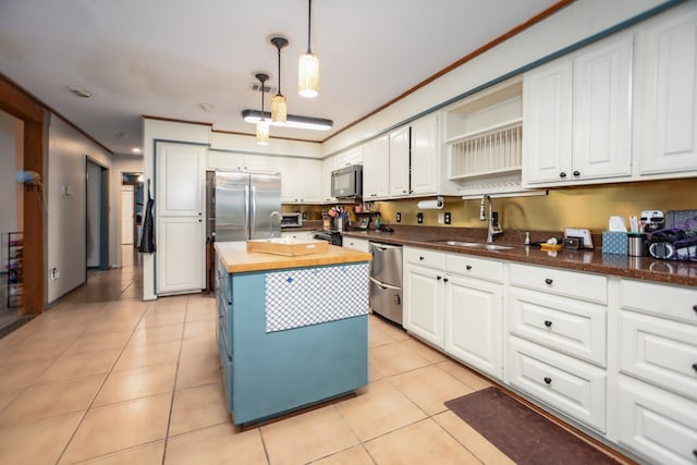310 Karen Dr, Lufkin, TX 75904 - kitchen featuring butcher block counters, a sink, white cabinetry, and stainless steel appliances