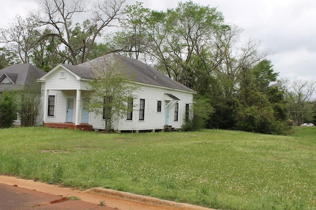306 S Harrison, San Augustine, TX 75972 - view of side of home with a lawn and a porch