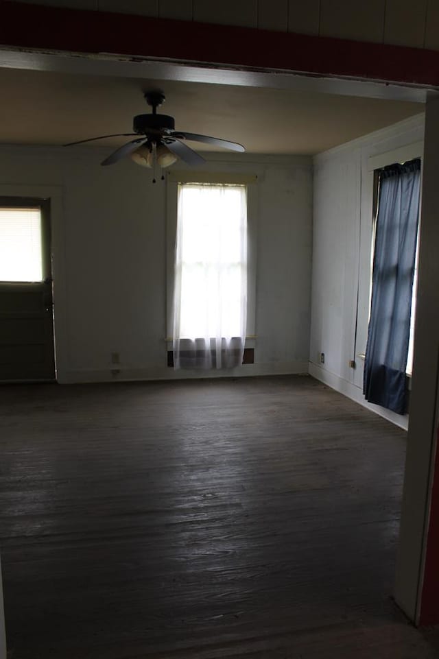 306 S Harrison, San Augustine, TX 75972 - empty room featuring wood finished floors, a ceiling fan, and beam ceiling