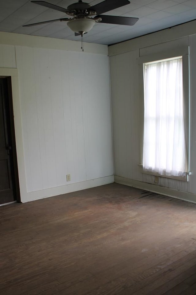 306 S Harrison, San Augustine, TX 75972 - unfurnished room featuring ceiling fan, dark wood-type flooring, and baseboards