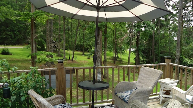 wooden deck featuring a lawn