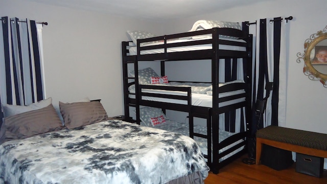 bedroom with dark wood-type flooring