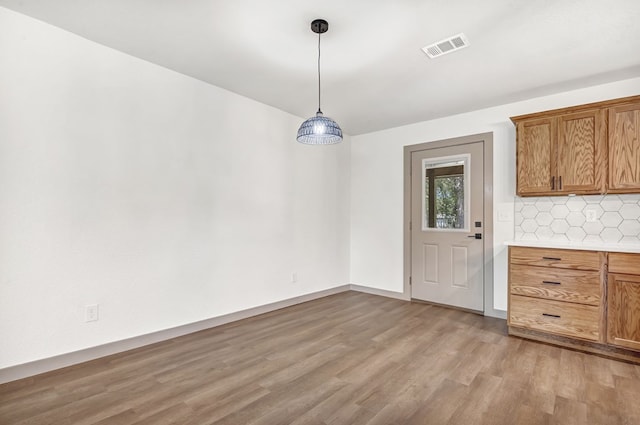 unfurnished dining area featuring light hardwood / wood-style floors