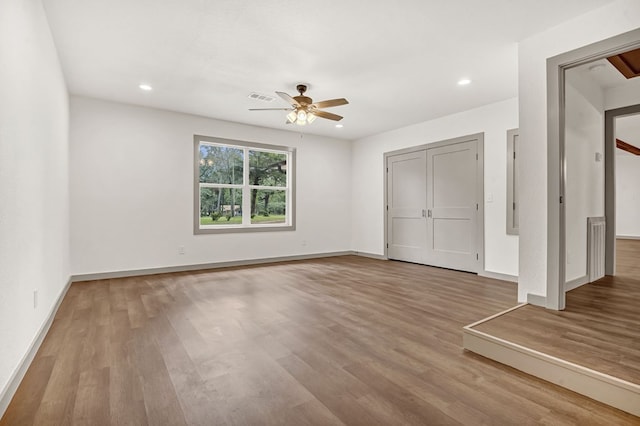 unfurnished bedroom featuring ceiling fan and light hardwood / wood-style flooring