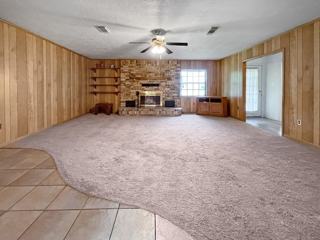 33963 US Highway 96, Buna, TX 77612 - unfurnished living room with wooden walls, visible vents, and ceiling fan
