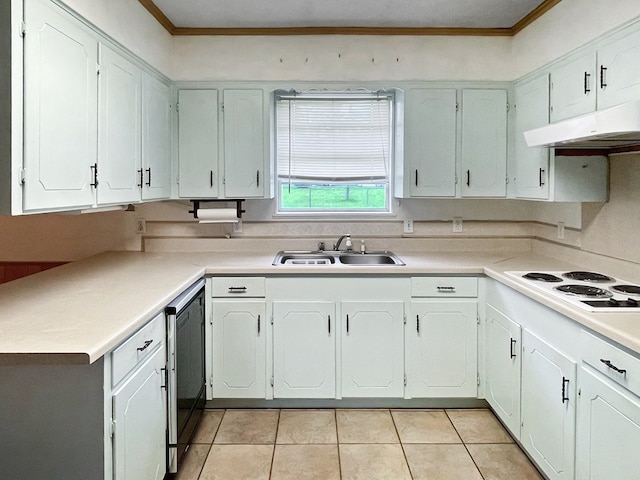 33963 US Highway 96, Buna, TX 77612 - kitchen with light tile patterned floors, under cabinet range hood, dishwasher, a sink, and white electric stovetop