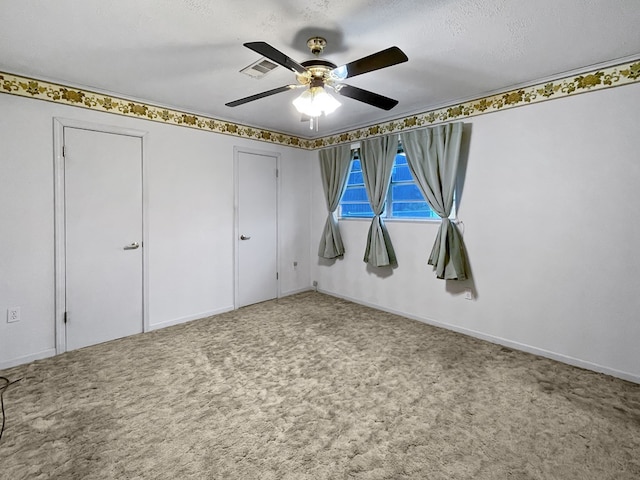 33963 US Highway 96, Buna, TX 77612 - unfurnished bedroom with visible vents, ceiling fan, two closets, and carpet floors