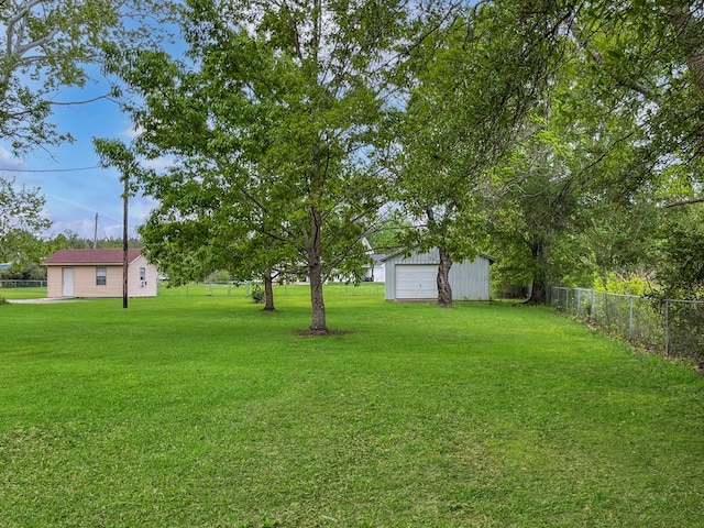 33963 US Highway 96, Buna, TX 77612 - view of yard featuring fence, an outbuilding, and a detached garage
