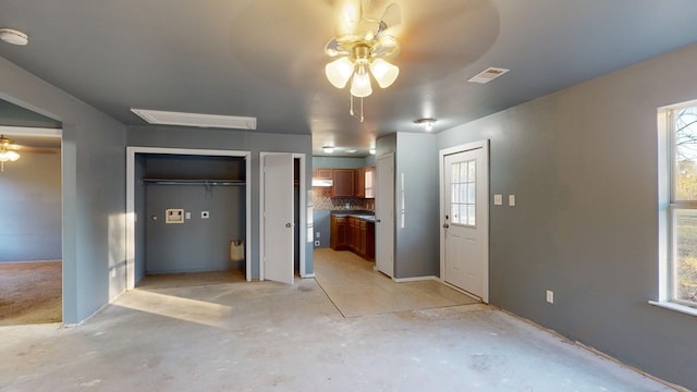 unfurnished bedroom with ceiling fan and ensuite bathroom