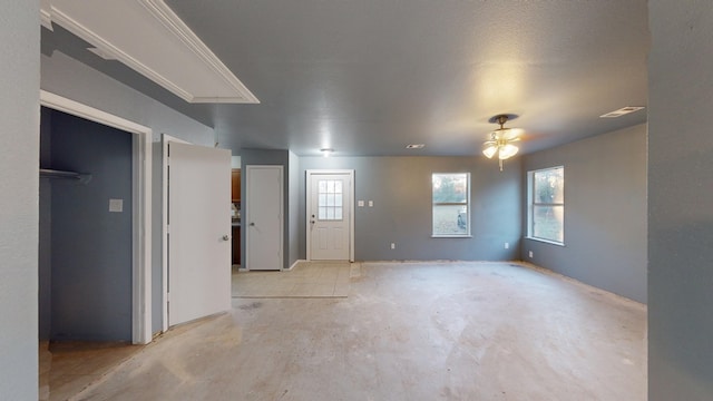 interior space featuring ceiling fan and a textured ceiling