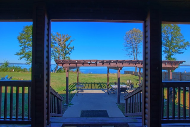 wooden terrace featuring a pergola, a yard, and a patio