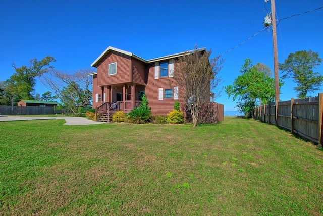 rear view of property featuring a yard