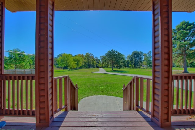 wooden terrace featuring a lawn