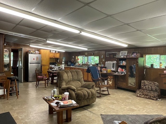 4499 Weaver Bend Rd, Huntington, TX 75949 - living area with light floors, wooden walls, and a drop ceiling