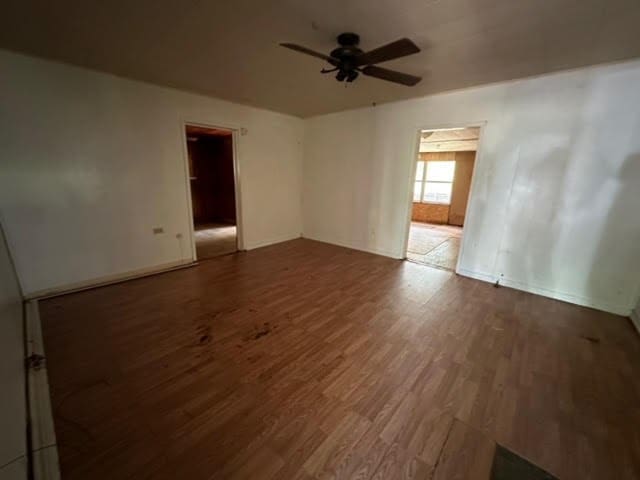 spare room with ceiling fan and wood-type flooring