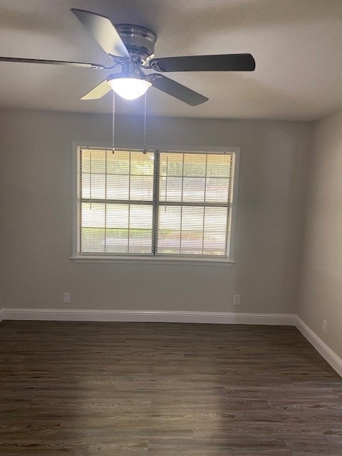 unfurnished room featuring ceiling fan and dark hardwood / wood-style floors