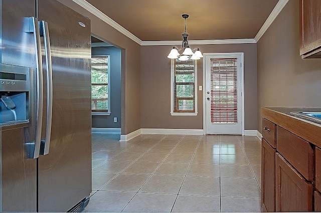 interior space featuring a chandelier, stainless steel fridge, decorative light fixtures, and crown molding