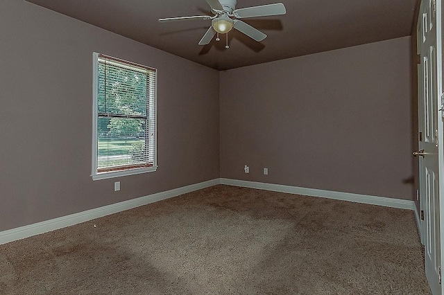 carpeted spare room with ceiling fan