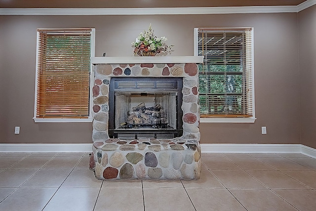 room details featuring a stone fireplace and ornamental molding