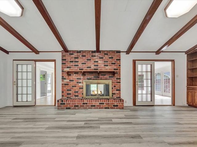 200 Platt Rd, Lufkin, TX 75904 - unfurnished living room featuring light wood finished floors, healthy amount of natural light, and a brick fireplace