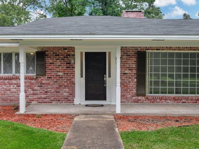 200 Platt Rd, Lufkin, TX 75904 - property entrance featuring brick siding, a chimney, and a porch