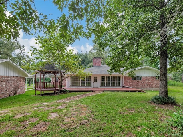 200 Platt Rd, Lufkin, TX 75904 - rear view of house featuring a gazebo, brick siding, a deck, a chimney, and a lawn