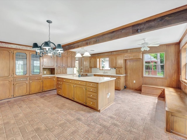 200 Platt Rd, Lufkin, TX 75904 - kitchen featuring brick patterned floors, a chandelier, light countertops, a center island, and beamed ceiling
